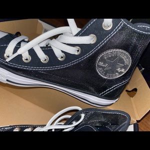 Mesh converse with pink bottoms.